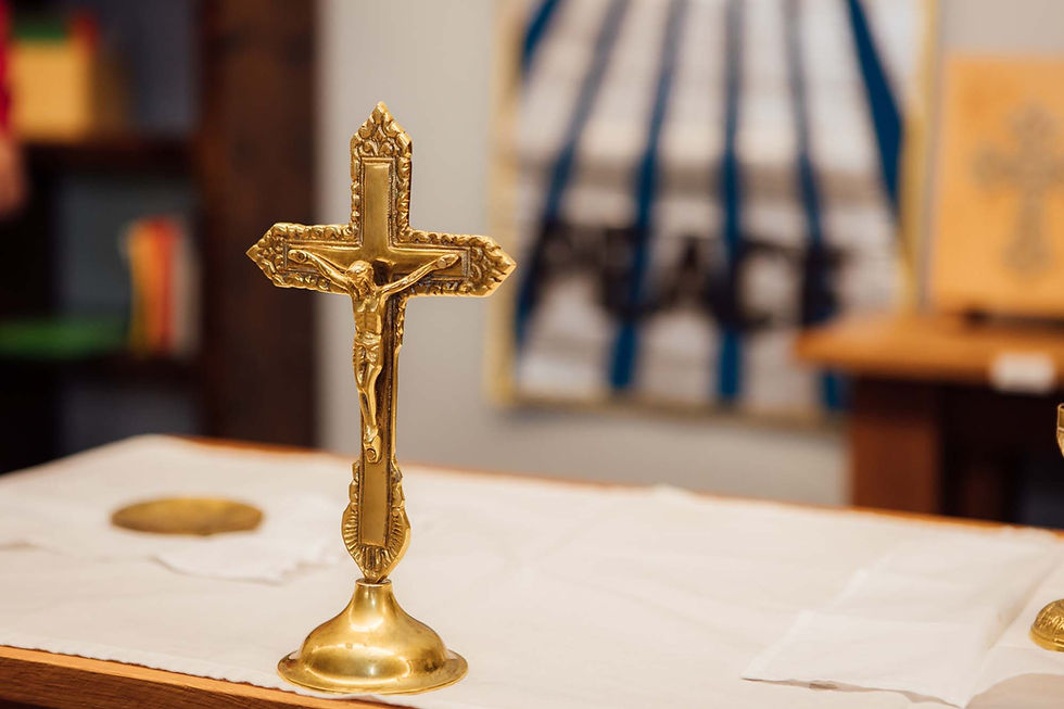 A gold crucifix on a white altar